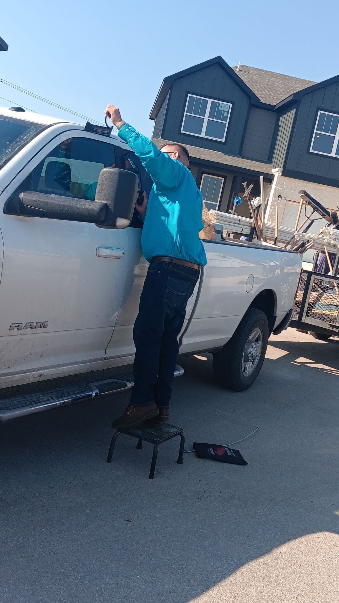 Nick unlocking a white Ram truck at a construction site